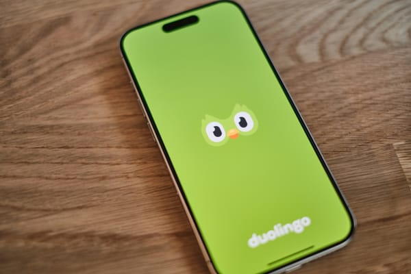 Smartphone showing Duolingo logo, highlighting top language learning platform